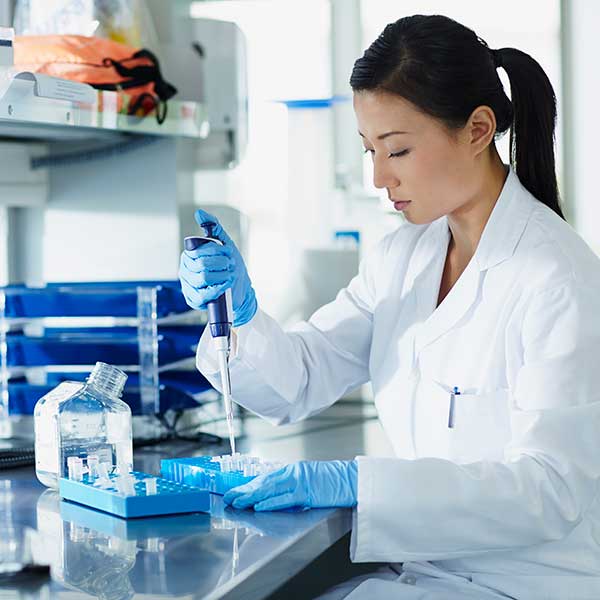 Scientist pipetting samples into tubes